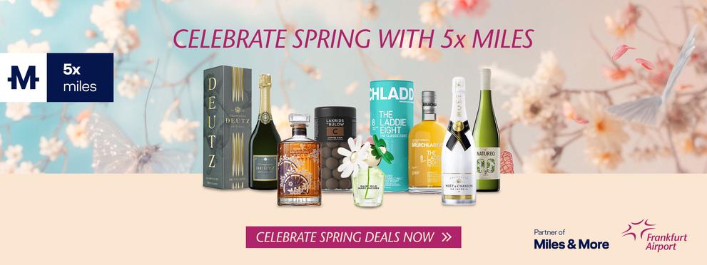 An advert for a spring promotion advertising the earning of five times miles with Miles & More, with a selection of products such as champagne and whisky against a floral background. Frankfurt Airport is mentioned as a partner.