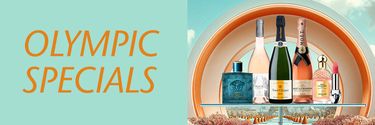  The image shows a banner with "OLYMPIC SPECIALS" on a turquoise background and a shelf with luxury items like bottles and lipstick against a decorative backdrop.