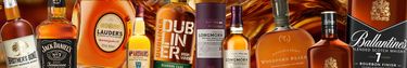 Promotional banner featuring a selection of whiskey bottles on an orange background