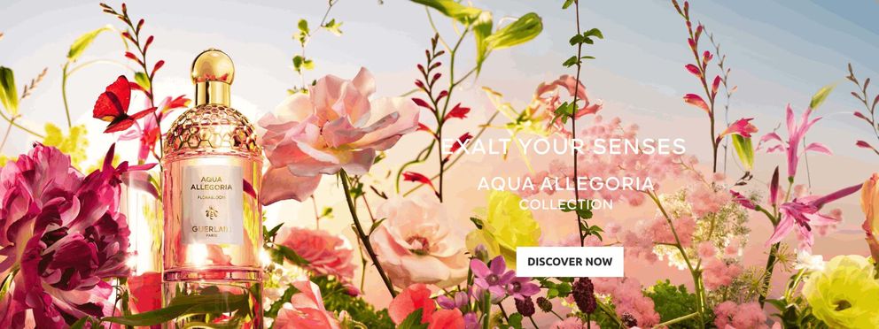 Bottle of Guerlain perfume "Rose Verde" from the Aqua Allegoria collection, surrounded by pink rose petals and cucumber slices. Text on the image: "Aqua Allegoria Rose Verde - The New Feel-good Fragrance. More than 90% natural origin.
