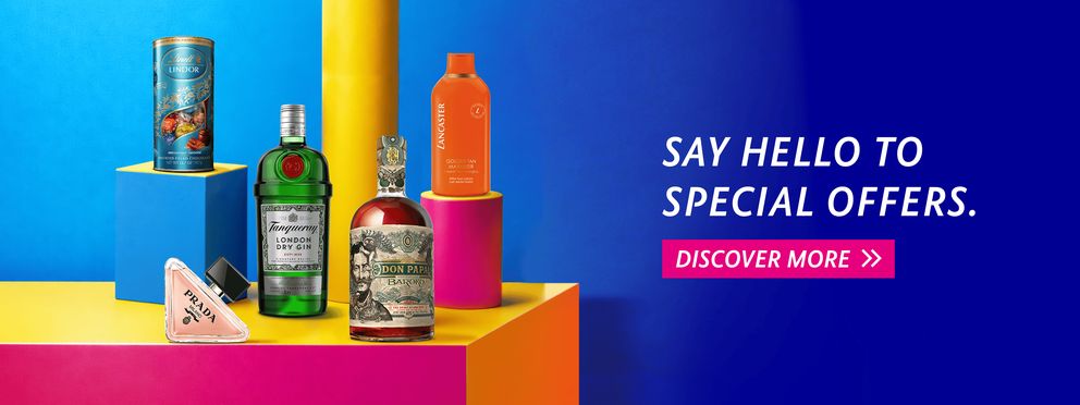 Promotional banner with special offer products: Lindt Lindor chocolates, Tanqueray gin, Don Papa Baroko rum, Lancaster Golden Tan Maximizer, and Prada Milano perfume on a modern blue background with "Say Hello to Special Offers" text and "Discover more"