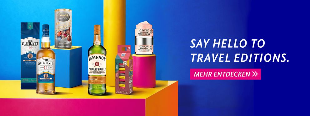 Bunte Werbegrafik mit Travel Edition Produkten: Glenlivet Whisky, Lindt Lindor Chocolates, Jameson Whiskey, Nut Selection und Clinique Moisture Surge vor farbigem Hintergrund mit Text "Say Hello to Travel Editions" und Button "Mehr entdecken".